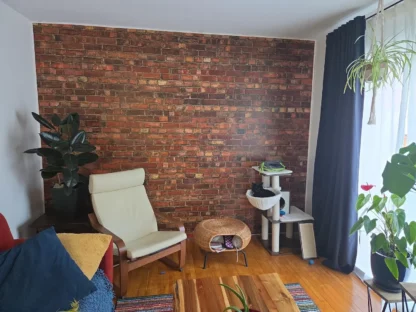 Old Brick Wall Mural, as seen on the wall of this industrial looking living room, is a wall mural created from a high resolution image that offers a realistic and textured red brick look from About Murals.