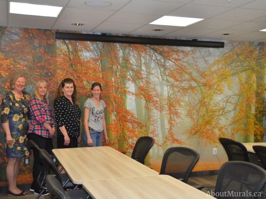 Autumn is Here Wall Mural, as seen in this boardroom, features yellow and orange trees in a misty forest. Forest wallpaper sold by AboutMurals.ca.