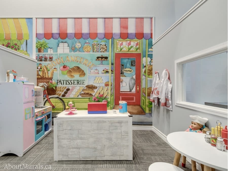 Bakery Wall Mural, as seen in this indoor playground, features a boulangerie full of cupcakes, cake, cookies and muffins. Kids wallpaper sold by AboutMurals.ca.