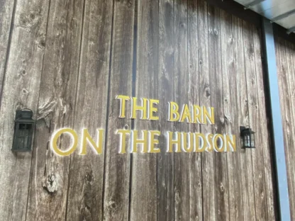 Barn Wood Wallpaper, as seen on the wall of this restaurant called "The Barn on the Hudson", is a high resolution photo mural of a rustic wood wall that looks realistic from About Murals.