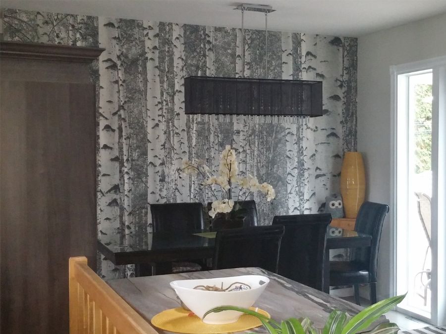 Black and White Birch Tree Wallpaper, as seen on the wall of this eat in kitchen, is a photo mural of tree trunks full of knots and peeling bark from About Murals.