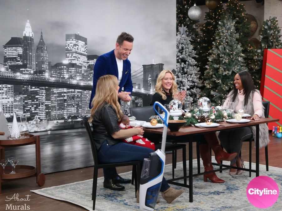 A removable wallpaper featuring the Brooklyn Bridge is the backdrop to a dining room scene on set at Cityline with Tracy Moore, Shai DeLuca, Shoana Jensen and Karen Sealy, by AboutMurals.ca