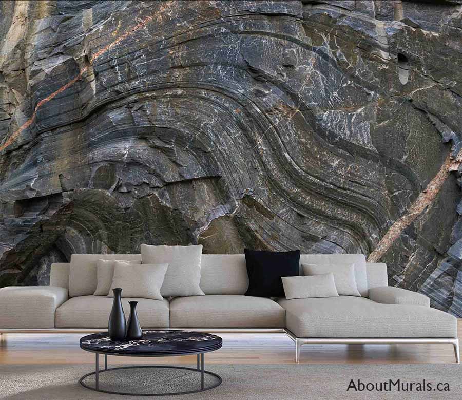 Canadian Shield Swirl Wall Mural, as seen on the wall of this rustic living room, is a photo mural of a rock face wall from About Murals.