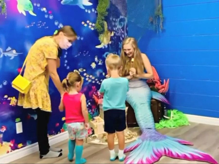 Fish Wall Mural, as seen in this mermaid themed party venue, is a children’s fish wallpaper mural with cute dolphins, shark and sea turtles from About Murals.