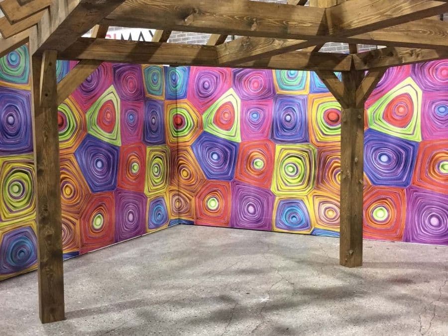 Hypnosis Wall Mural, as seen at this tradeshow, features trippy geometric shapes from About Murals.
