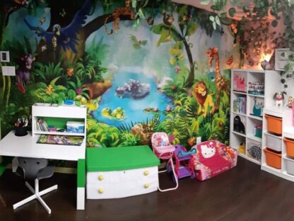 Jungle Wall Mural, as seen in this girl bedroom, is a jungle animal wallpaper with a cartoon lion, giraffe, monkey, hippo, cougar and parrot from About Murals.