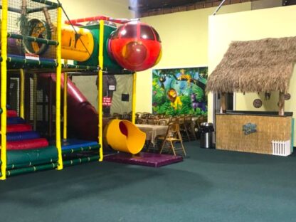 Jungle Wall Mural, as seen in this indoor jungle gym, is a children’s wallpaper with cute animals in a rainforest from About Murals.