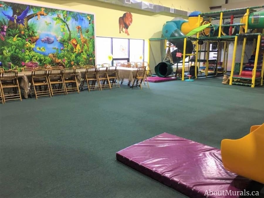 Jungle Wall Mural, as seen in this indoor playground, is a children’s wallpaper mural with fun safari animals from About Murals.
