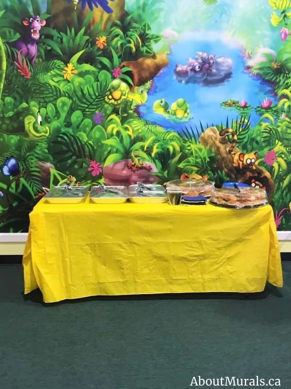 Jungle Wall Mural, as seen in this party place for preschoolers, is a washable wallpaper with fun animals from About Murals.