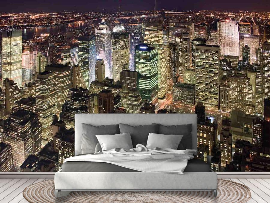 Manhattan at Night Wallpaper, as seen on the wall of this grey bedroom, is an aerial photo mural of a modern city skyline under a black sky from About Murals.