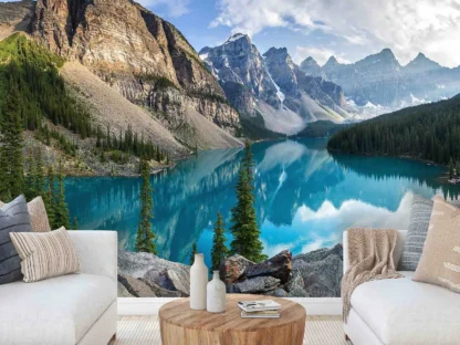 Moraine Lake Wallpaper, as seen on the wall of this living room, is a landscape mural of mountains in Banff National Park, Canada reflected in a blue glacier lake from About Murals.