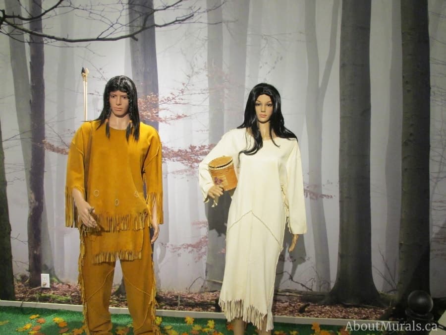 Morning fog wall mural is a forest themed wallpaper pictured here in Grande Prairie Museum's exhibit behind mannequins. Sold by AboutMurals.ca