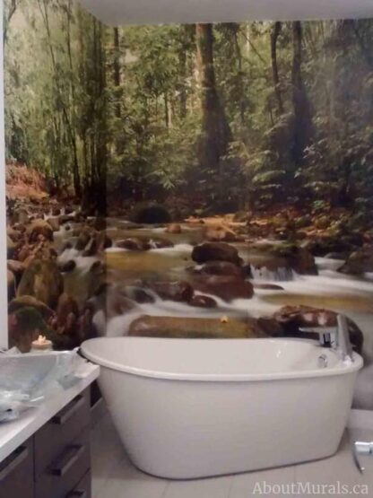 Mountain Stream Wall Mural, as seen on the wall of this modern bathroom, features a babbling brook flowing through a mossy green forest. Forest wallpaper sold by AboutMurals.ca.