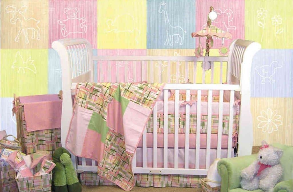 Pastel Animal Wallpaper, as seen on the wall of this nursery, features silhouettes of white animals against a soft pink, blue, yellow, orange or green background from About Murals.