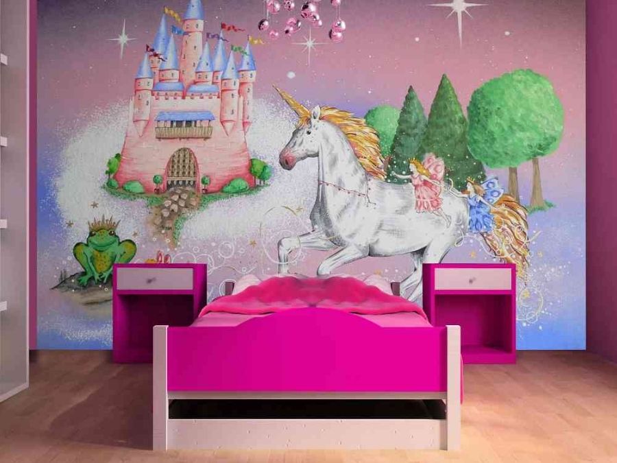 Princess Castle Wallpaper, as seen on the wall of this pink bedroom, is a princess wall mural with a magical castle, white unicorn, frog prince and fairies from About Murals.
