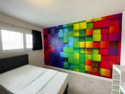 Rainbow Cubes Wall Mural, as seen in this kids bedroom, is wallpaper that features colourful 3D looking cube squares from About Murals.