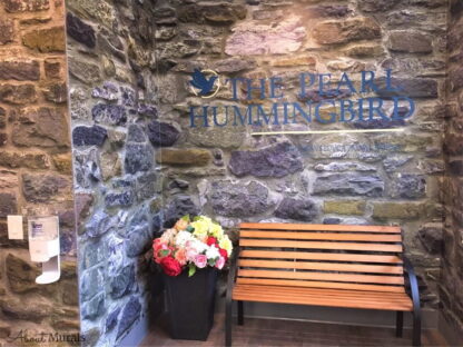Stone Wall Mural, as seen in this educational centre, features grey stacked stones with hints of purple, blue and yellow. Stone wallpaper sold by AboutMurals.ca.
