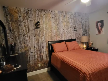 White Birch Wallpaper, as seen on the wall of this AirBNB, is a forest mural with natural trees from About Murals.