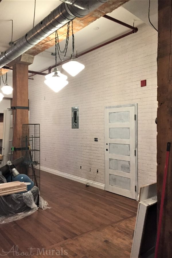 White Brick Wall Mural, as seen in this loft, adds a ton of texture to walls with its white painted brick. Brick wallpaper sold by AboutMurals.ca.