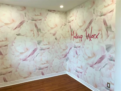 Custom Wallpaper with a logo over a floral design, as seen on the wall of Makeup Worx in Hamilton, Ontario, from About Murals.