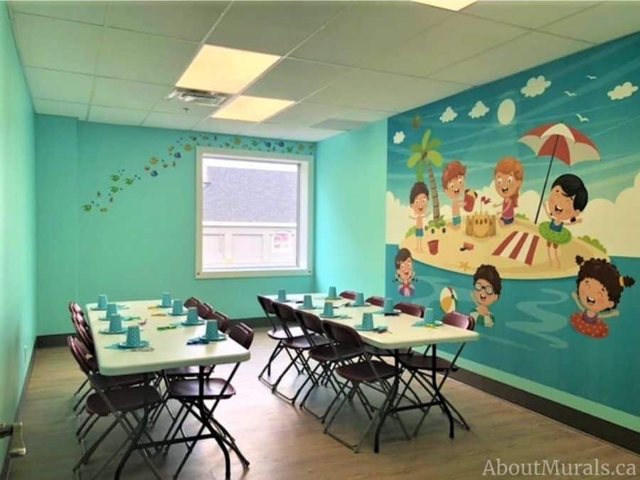 Custom wallpaper, as seen on the wall of this childrens party venue, is a wall mural of kids playing on a beach from About Murals.