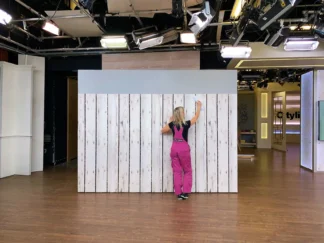 Wallpaper installer, Adrienne of About Murals, hanging wallpaper on TV set Cityline.