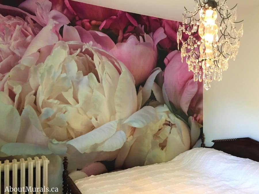 Peony Wallpaper, as seen on the wall of this bedroom, features soft pink petals. Flower wallpaper sold by About Murals.