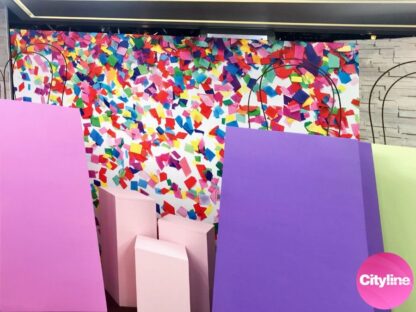A confetti wallpaper by AboutMurals.ca is on a Cityline set with gift bags ready for audience members