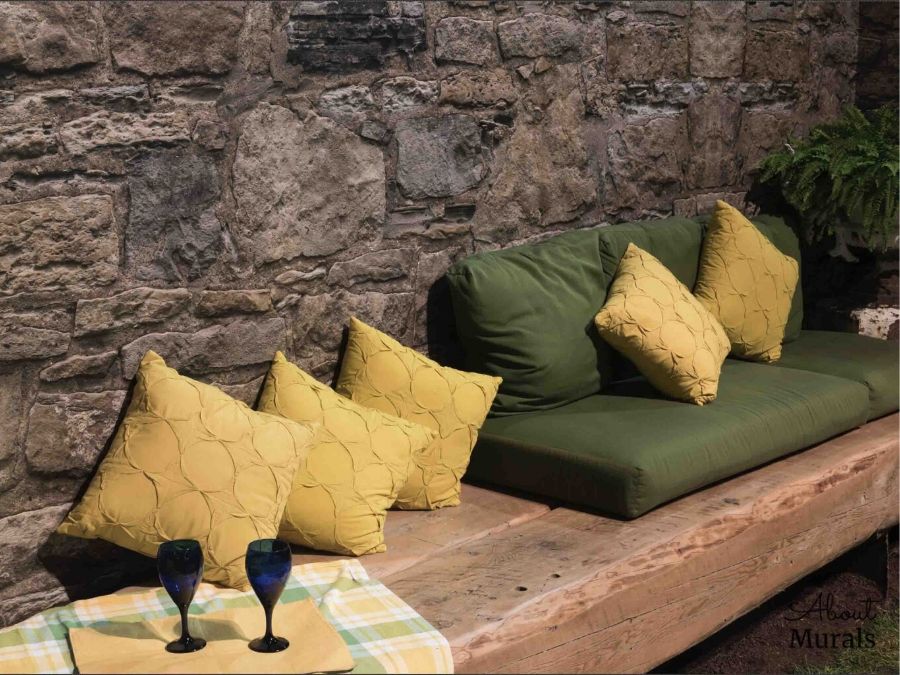 Castle Stone Wallpaper, as seen over this bench, features a wall of textured brown rock. Easy wallpaper sold by AboutMurals.ca.