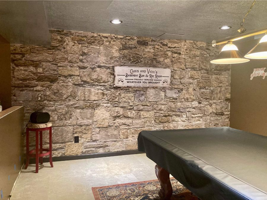 Castle Stone Wallpaper, as seen on the wall of this billiards room next to a pool table, is a photo wall mural of rustic brown stones that are realistic looking from About Murals.