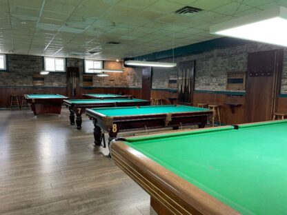 Castle Stone Wallpaper, as seen on the wall of this pool hall called "Main Billiards Lounge", is a photo wallpaper of realistic, textured brown stones from About Murals.