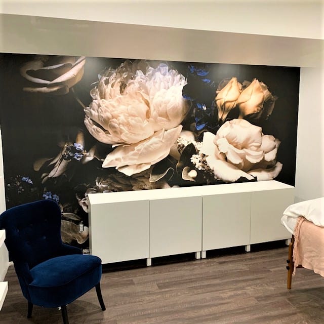 Black Floral Wallpaper, as seen on the wall of this spa, features beautiful rose and peony flowers on a dark background. Floral wallpaper sold by AboutMurals.ca.