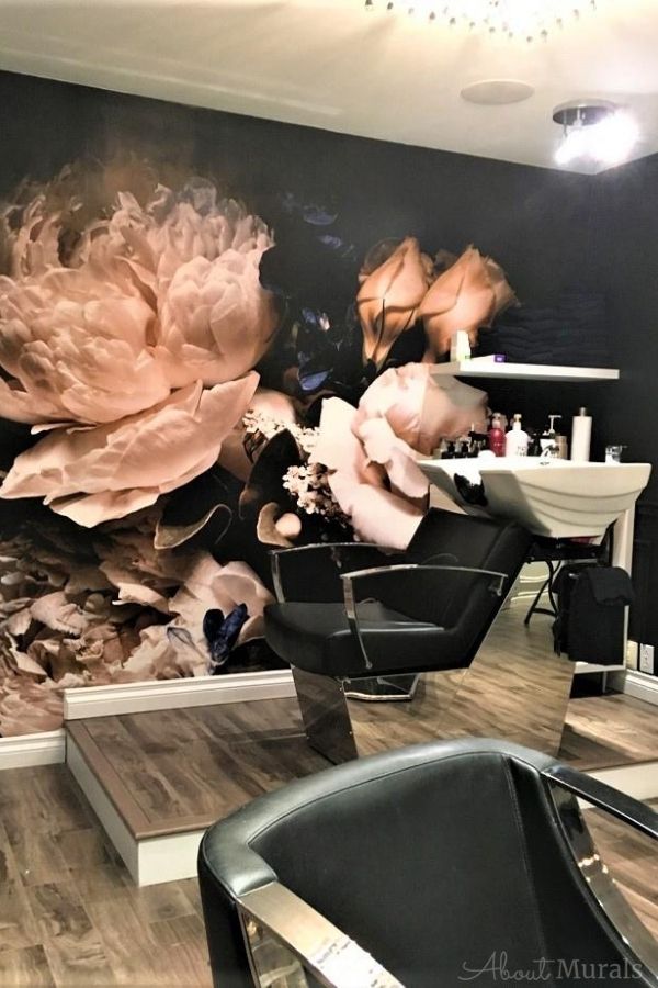 This black floral wallpaper, as seen on the wall of this hair salon, features roses and peonies on a dark background. Flower wallpaper sold by AboutMurals.ca.