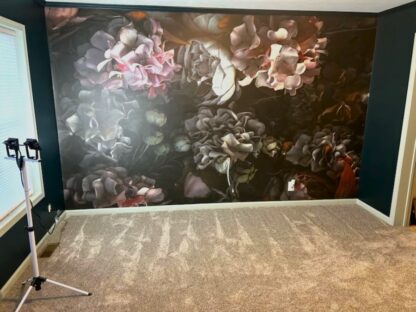 Dark Floral Wallpaper, as seen on the wall of this room with adjacent walls painted in dark green, is a mural with large white and pink peony flowers on a black background from About Murals.