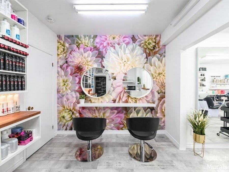 Pink Flower Wallpaper, as seen on the wall of this hair salon, features a closeup of dahlia flowers. Floral wallpaper sold by AboutMurals.ca.