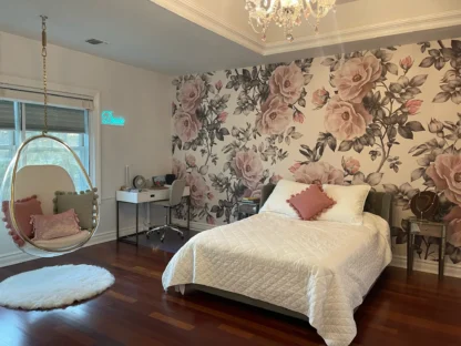 Vintage Flower Wallpaper, as seen on the wall of this bedroom, is a floral mural with antique roses in pink and grey from About Murals.