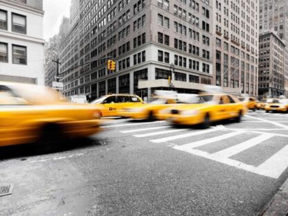 New York Yellow Taxi Wallpaper is a mural of yellow cabs against black and white New York buildings from About Murals.
