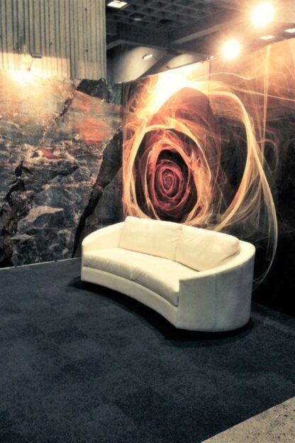 Yellow Fractal Flower Wallpaper, as seen on the wall at this tradeshow, features an abstract yellow rose on a black background from About Murals.
