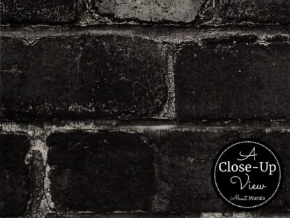 A close-up view of a black brick wallpaper from About Murals.