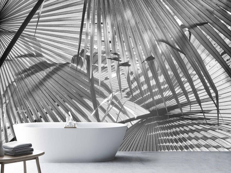 Black and White Palm Wallpaper, as seen on the wall of this bathroom, is a photo mural of grey palm leaves from About Murals.