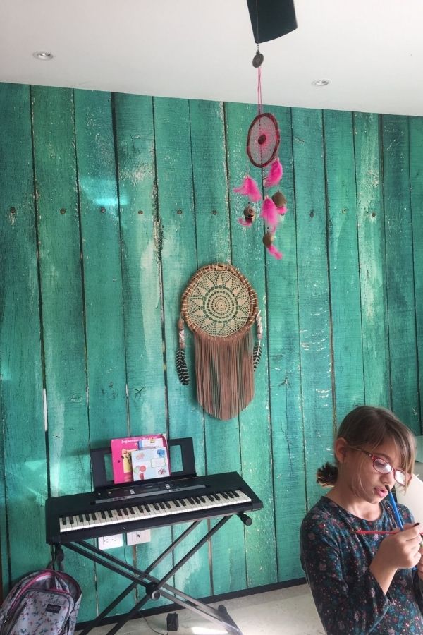 Turquoise Wood Wallpaper, as seen in this playroom, features aquamarine wood panels from About Murals.
