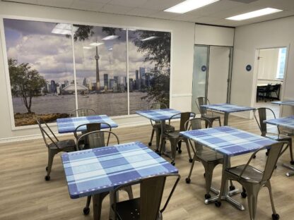 Toronto Wallpaper, as seen on the wall of this school lunchroom, is a photo wallpaper featuring the CN Tower as seen from across Lake Ontario from About Murals