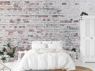 Distressed Brick Wallpaper, as seen on the wall of this bedroom, features white decaying paint over red brick from About Murals.