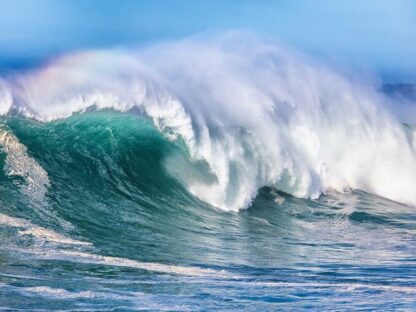 Ocean Wave Wallpaper is a photo mural of a cresting blue wave from About Murals.