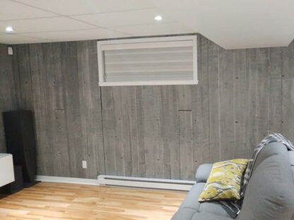 Concrete Look Wallpaper, as seen on the wall in this basement, is a photo wallpaper of concrete slabs from About Murals.