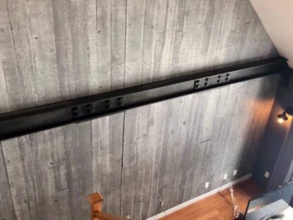 Concrete Look Wallpaper, as seen on the wall of this staircase, is a high resolution photo mural of grey concrete planks from About Murals.