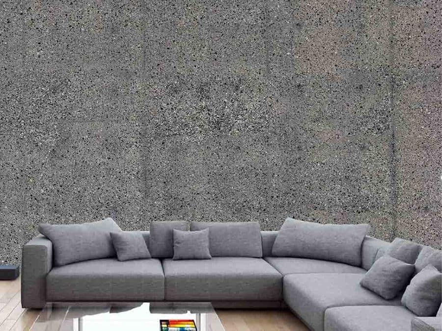 Concrete Stone Wallpaper, as seen on the wall of this grey living room, is a photo mural of concrete pebbles from About Murals.
