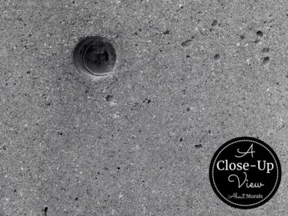 A close-up view of a tie hole in a concrete wallpaper sold by About Murals