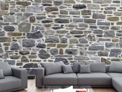Country Stone Wallpaper, as seen on the wall of this grey living room, is a wall mural with realistic stones from About Murals