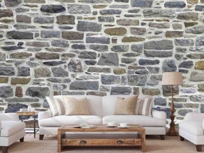 Country Stone Wallpaper, as seen on the wall of this white living room, is a photo mural of a pastel fieldstone wall from About Murals.